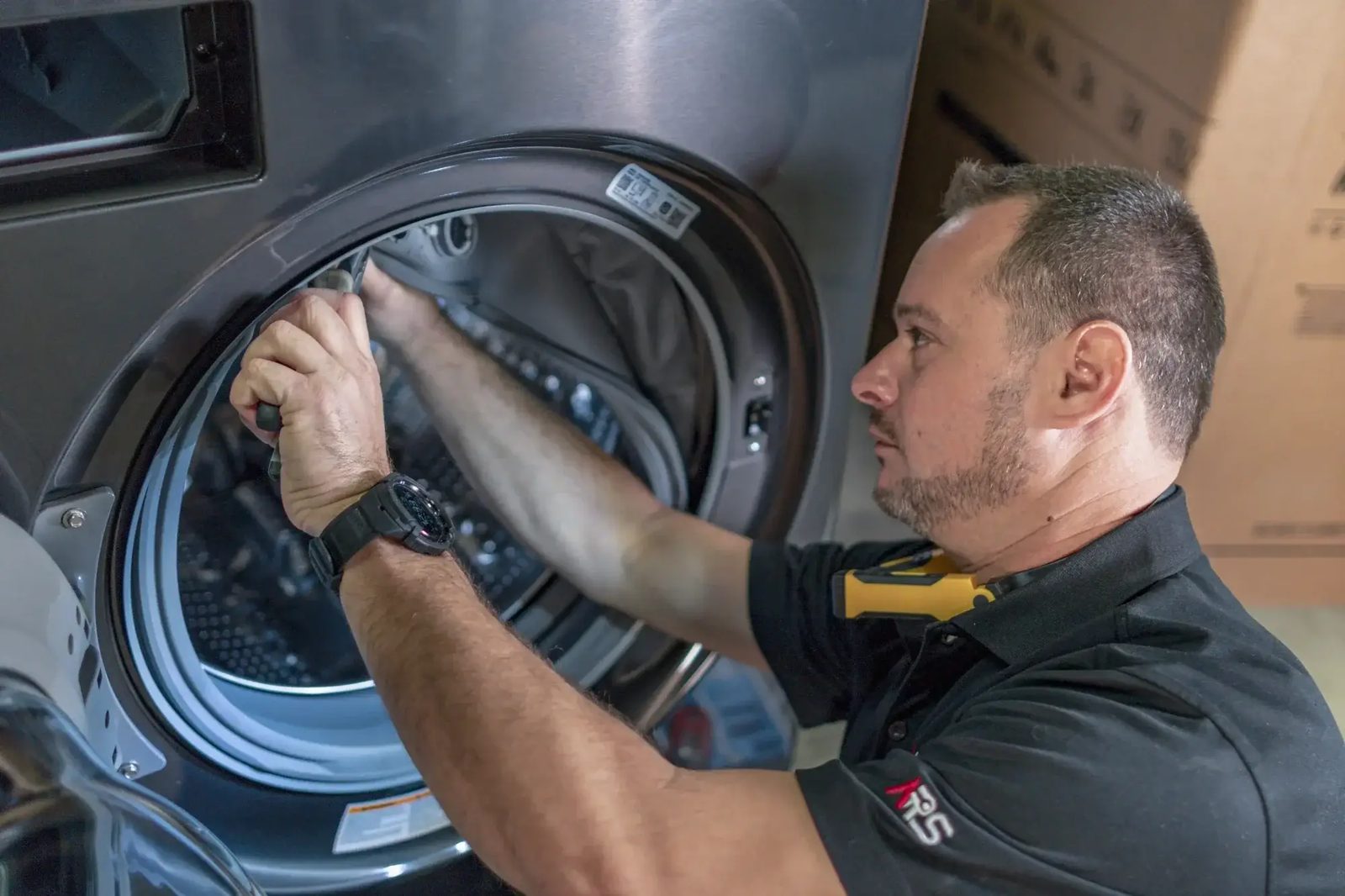 Technician working inside the drum of a front load washer